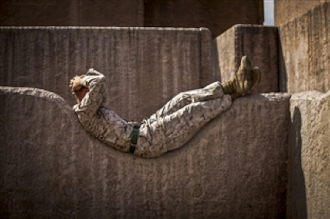 Marine Lance Cpl. Curtis E. Sledge relaxes on a rock wall before participating in a night raid on Marine Corps Base Hawaii, April 17, 2015. Sledge is a machine gunner assigned to Alpha Company, 1st Battalion, 3rd Marine Regiment.
