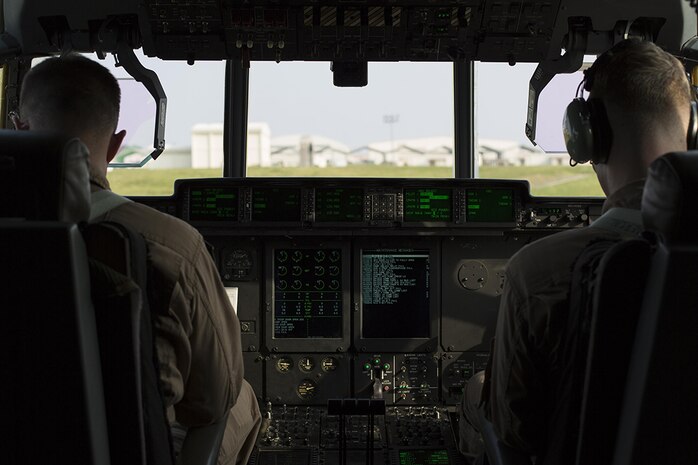 Capt. Charles Casey, left, an aircraft commander with Marine Aerial Refueler Transport Squadron 152, and 1st Lt. Jacob Billups, a pilot with VMGR-152, prepare to take flight to Iwo To, formally known as Iwo Jima, from Kadena Air Base, Japan, March 22, 2015. VMGR-152 provided transportation for Marines, VIPs and vehicles. The Reunion of Honor is a ceremony honoring veterans still alive from the battle of Iwo Jima in 1945.