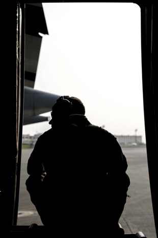 Cpl. Eli Wallace, a crew master with Marine Aerial Refueler Transport Squadron 152, awaits for take-off on a Lockheed KC-130J Hercules on Kadena Air Base, Japan, March 22, 2015. VMGR-152 flew back and forth from Kadena to Iwo To, formally known as Iwo Jima, providing transportation for Marines, VIPs and vehicles. The Reunion of Honor is a ceremony honoring veterans still alive from the battle of Iwo Jima in 1945.