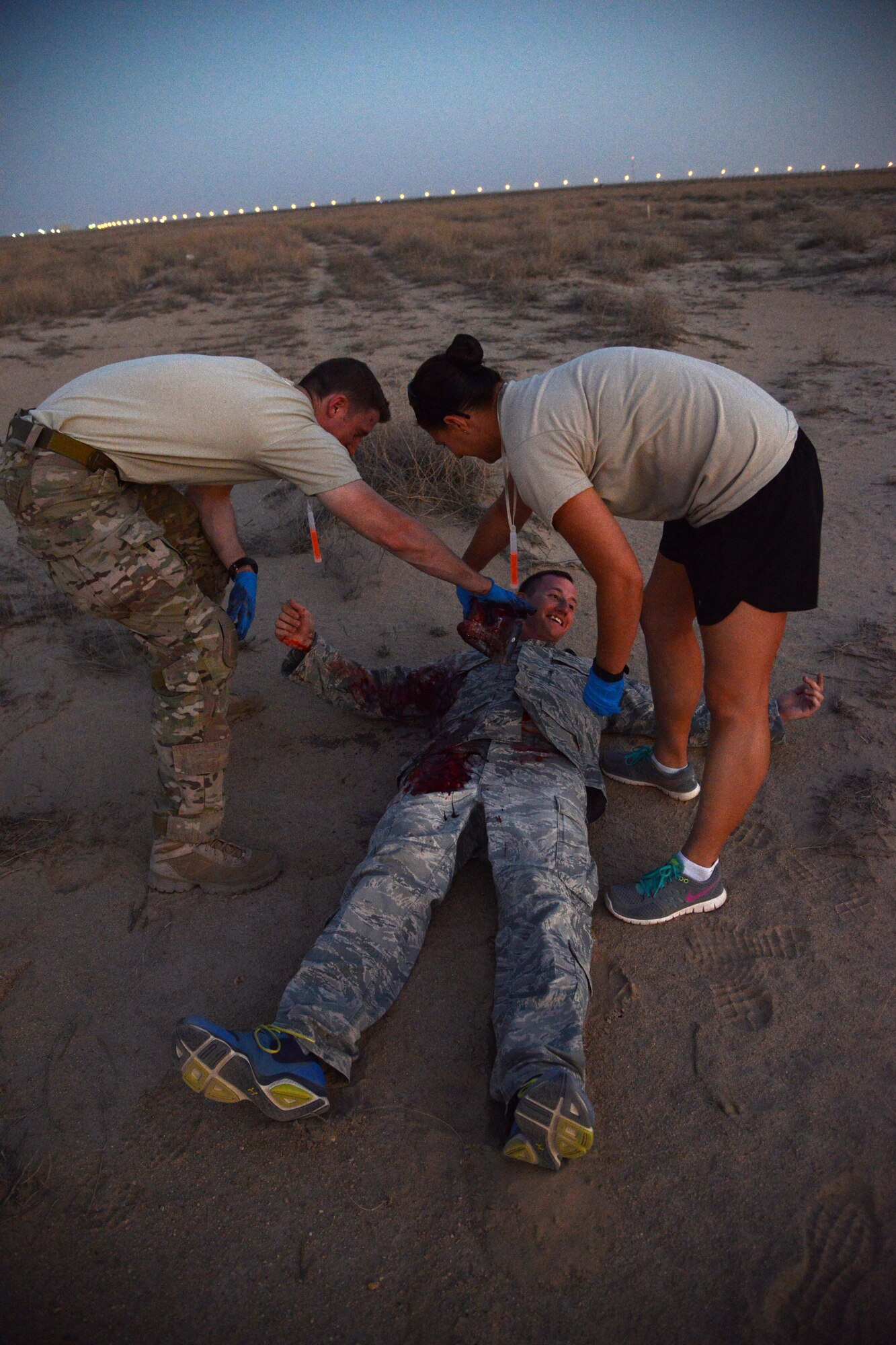 Airmen prepare a volunteer during a mass casualty exercise April 19, 2015. The exercise tested the response of pararescue team members during a simulated plane crash with 12 victims. The 52nd ERQS is the primary personnel recovery unit supporting Operation INHERENT RESOLVE. (U.S. Air Force photo by Tech. Sgt. Jared Marquis/released)