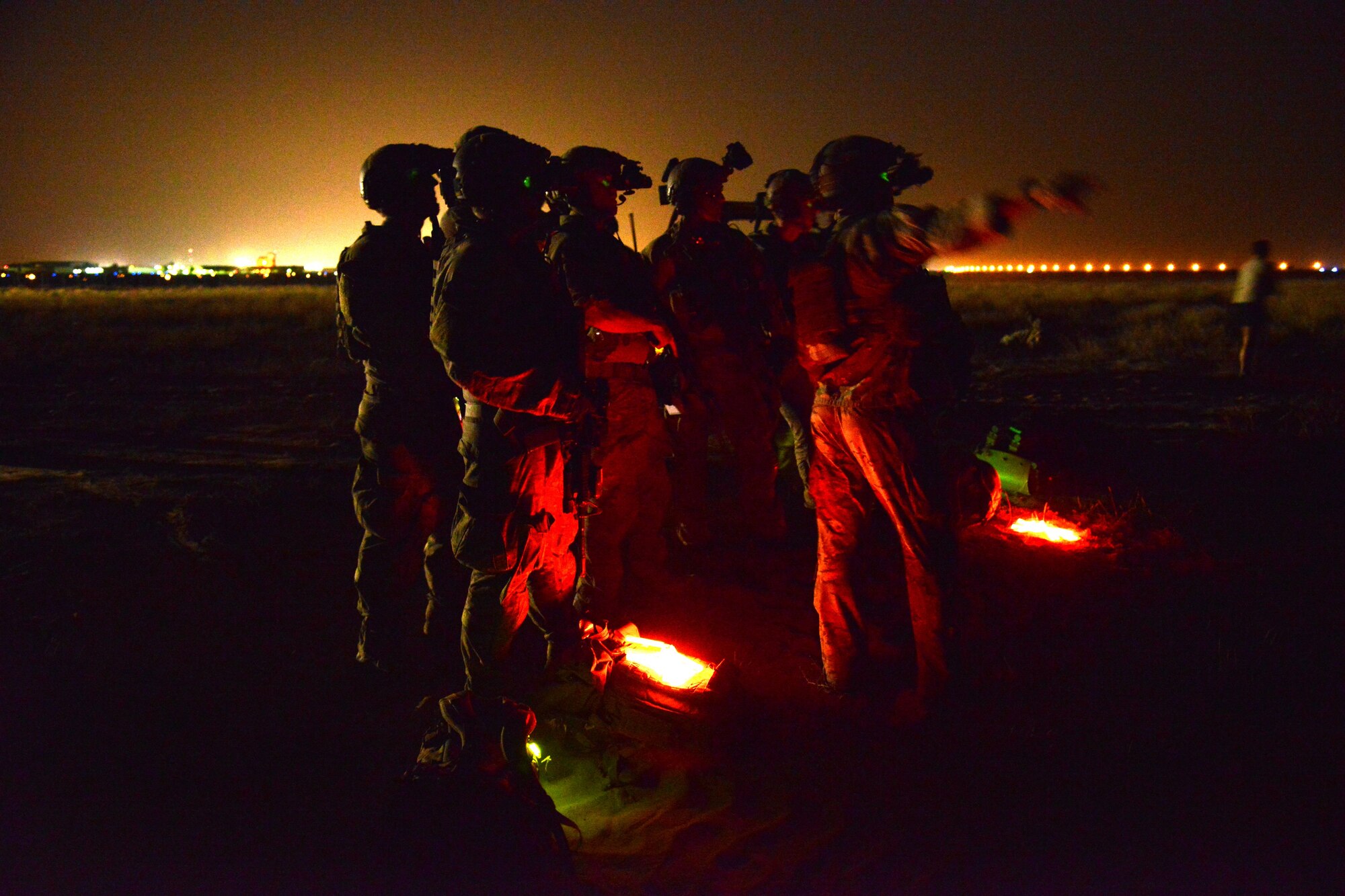 A pararescue team element leader with the 52nd Expeditionary Rescue Squadron directs team members during a mass casualty exercise April 19, 2015. The exercise tested the response of pararescue team members during a simulated plane crash with 12 victims. The 52nd ERQS is the primary personnel recovery unit supporting Operation INHERENT RESOLVE. (U.S. Air Force photo by Tech. Sgt. Jared Marquis/released)