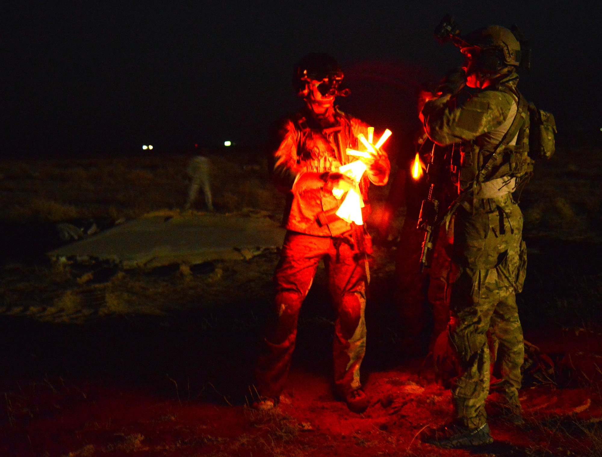 Pararescue team members with the 52nd Expeditionary Rescue Squadron prepare chemical lights to aid in patient search and rescue during a mass casualty exercise April 19, 2015. The exercise tested the response of pararescue team members during a simulated plane crash with 12 victims. The 52nd ERQS is the primary personnel recovery unit supporting Operation INHERENT RESOLVE. (U.S. Air Force photo by Tech. Sgt. Jared Marquis/released)