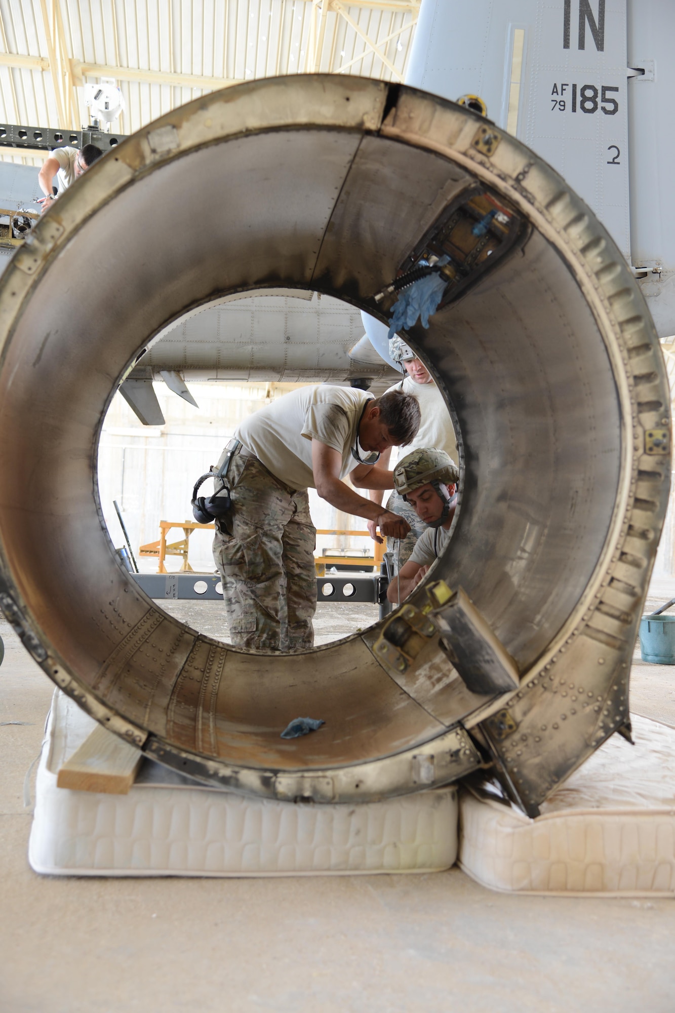 An Airman with the 332nd Expeditionary Maintenance Group prepares a damaged nacelle, the protective covering on the engine, from an A-10C Thunderbolt II for shipment at Al Asad Air Base, Iraq. A maintenance response team from the 332nd EMXG repaired the jet and got it back in the air less than five days after the jet suffered catastrophic engine failure and had to divert there. (U.S. Air Force photo by Tech. Sgt. Jared Marquis/released)