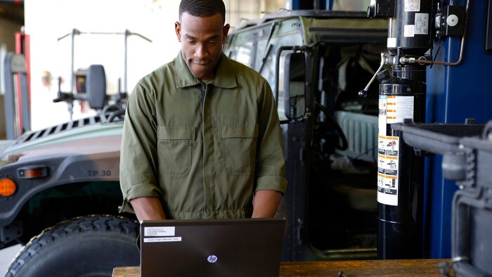 Lance Cpl. Cedric Hargrove enters data into Global Combat Support System-Marine Corps uses a laptop in a motor bay at The Basic School aboard Marine Corps Base Quantico, Virginia. Thanks to a recent GCSS-MC software update, Marines will be able to make better use of the logistics and resource management software system in limited-connectivity environments.