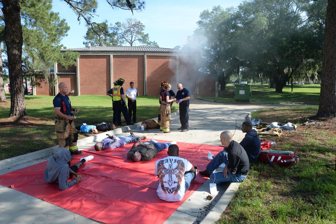 Marine Corps Logistics Base Albany firefighters/emergency medical technicians evaluate and provide medical treatment for burns and smoke inhalation to personnel as a result of a simulated fire at the Base Theater during the Raging Renegade active-shooter exercise, April 21. Installation Marines portrayed injured casualties for the exercise.