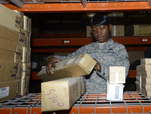 Airman 1st Class Bernice Yunwe Kwasinyui, a 22nd Logistics Readiness Squadron aircraft parts store technician, looks up part information April 22, 2015, at McConnell Air Force Base, Kan. Yunwe Kwasinyui, a Cameroon native, joined the Air Force to give back to the country that gave her an opportunity for a better life. (U.S. Air Force photo/Senior Airman Trevor Rhynes)