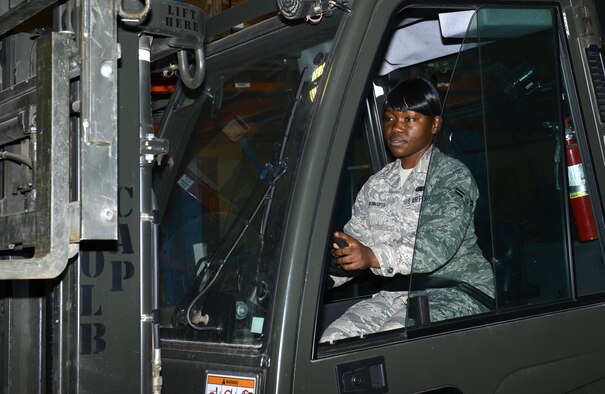 Airman 1st Class Bernice Yunwe Kwasinyui, a 22nd Logistics Readiness Squadron aircraft parts store technician, operates a forklift April 22, 2015, at McConnell Air Force Base, Kan. Yunwe Kwasinyui, left her home country of Cameroon after she won a visa to come to the U.S. (U.S. Air Force photo/Senior Airman Trevor Rhynes)