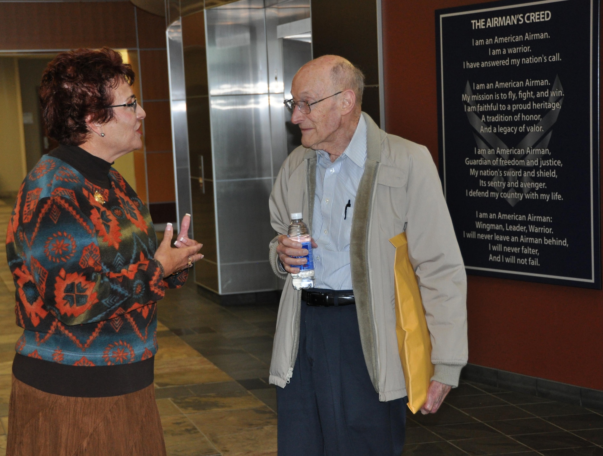 Former 1st Lt. Clayton A. Nattier, a veteran bomber pilot who was held as a prisoner of war during World War II, listens to retired Brig. Gen. Pat Quisenberry, evaluations branch chief, during his visit to the Air Reserve Personnel Center April 17, 2015, on Buckley Air Force Base, Colo. Along with Quisenberry, other members from the ARPC recognition service team who assisted Nattier are: Jacqueline Bing, sustainment division chief, Master Sgt. Jeremy Bohn, pre-trained individual manpower division chief, and Master Sgt. Richard Grybos, NCO in charge of training and development. Nattier worked in conjunction with retired Lt. Col. Kathryn Wirkus, a constituent service representative from U.S. representative Ed Perlmutter’s staff, to attain his POW Medal. A formal presentation to award the POW Medal to Nattier is currently being planned by U.S. representative Ed Perlmutter’s office. (U.S. Air Force photo/Tech. Sgt. Rob Hazelett)