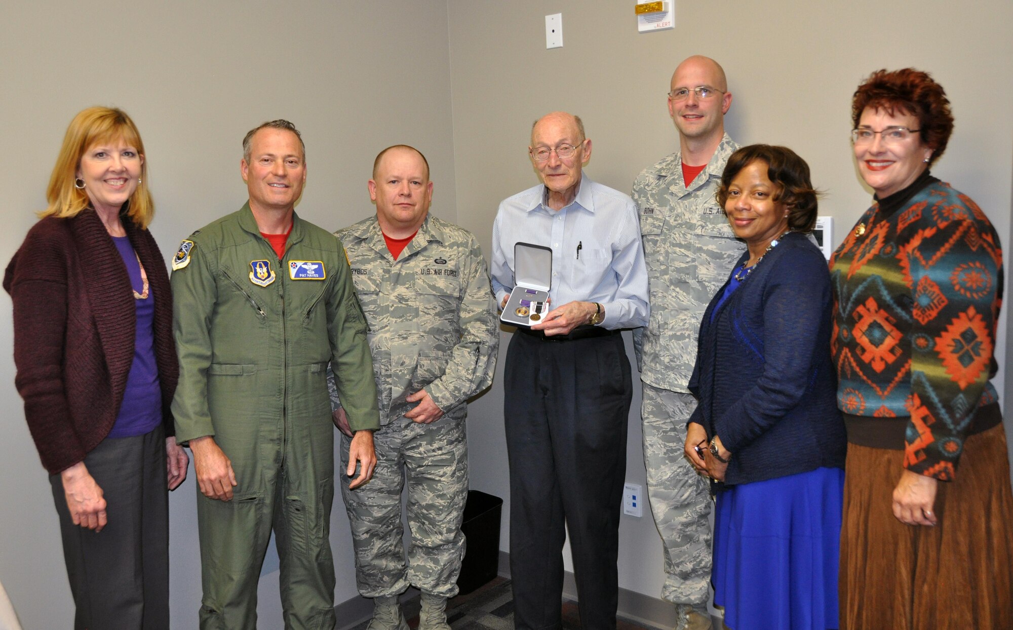 Former 1st Lt. Clayton A. Nattier, a veteran bomber pilot who was held as a prisoner of war during World War II, goes over the medals he received from the Air Reserve Personnel Center with Jacqueline Bing, sustainment division chief, April 17, 2015, on Buckley Air Force Base, Colo. Nattier visited ARPC to receive his POW Medal among various other medals, then took time to personally meet and thank the members on the recognition service team who assisted him. Along with Bing, other members from the ARPC recognition service team who assisted Nattier are: retired Brig. Gen. Pat Quisenberry, evaluations branch chief, Master Sgt. Jeremy Bohn, pre-trained individual manpower division chief, and Master Sgt. Richard Grybos, NCO in charge of training and development. Nattier worked in conjunction with retired Lt. Col. Kathryn Wirkus, a constituent service representative from U.S. representative Ed Perlmutter’s staff, to attain his POW Medal. A formal presentation to award the POW Medal to Nattier is currently being planned by U.S. representative Ed Perlmutter’s office. (U.S. Air Force photo/Tech. Sgt. Rob Hazelett)