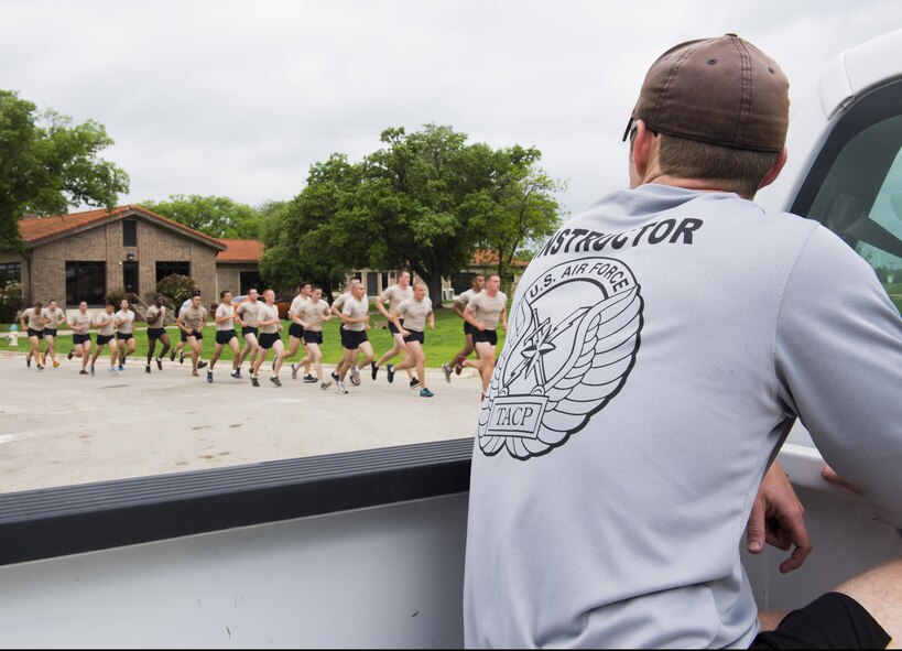A Tactical Air Control Party (TACP) instructor from the 342nd Training Squadron at Joint Base San Antonio-Lackland, oversees students during a group run. The Airmen will be a part of the first class to attend the TACP level-three apprentice course at JBSA-Lackland. The apprentice course was relocated from Hulburt Field Air Force Base, Florida. (U.S. Air Force photo by Airman First Class Justine Rho)