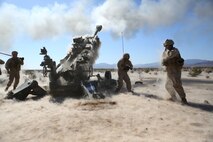 Marines with Battery A, 1st Battalion, 11th Marine Regiment, 1st Marine Division embrace the impact from the M777A2 155 mm, medium, towed howitzer during Exercise Desert Scimitar 2015 aboard Marine Corps Air Ground Combat Center Twentynine Palms, Calif., April 20, 2015. The tough, realistic live-fire training central to Desert Scimitar allows Division units to train in order to maintain readiness and meet current and real-world operational demands.