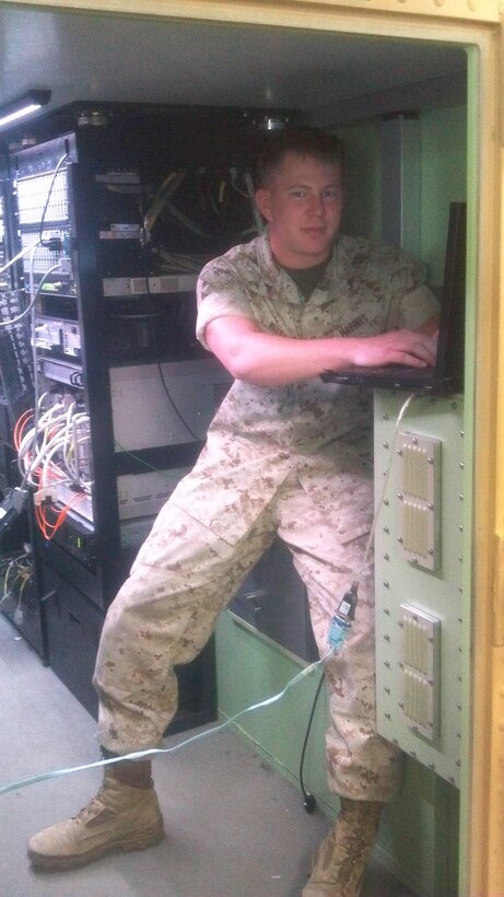 LCpl James T. Hutchison a student in Air Defense System Tech Course is seen working to re-establish working connections between systems.