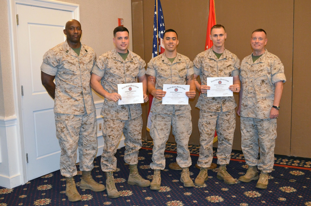 Cpl. Matthew Nolan, Sgt. Michael Hough and Lance Cpl. Braegan Lenarz receive certificates of appreciation for their work with the Navy-Marine Corps Relief Society.
