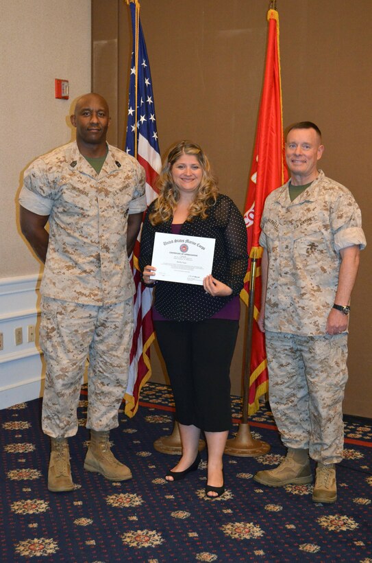 Women of the Chapel volunteer Holly Vega, center, poses with Headquarters and Service Battalion’s Sgt. Maj. Gerald Saunders Base Commander Col. David Maxwell.