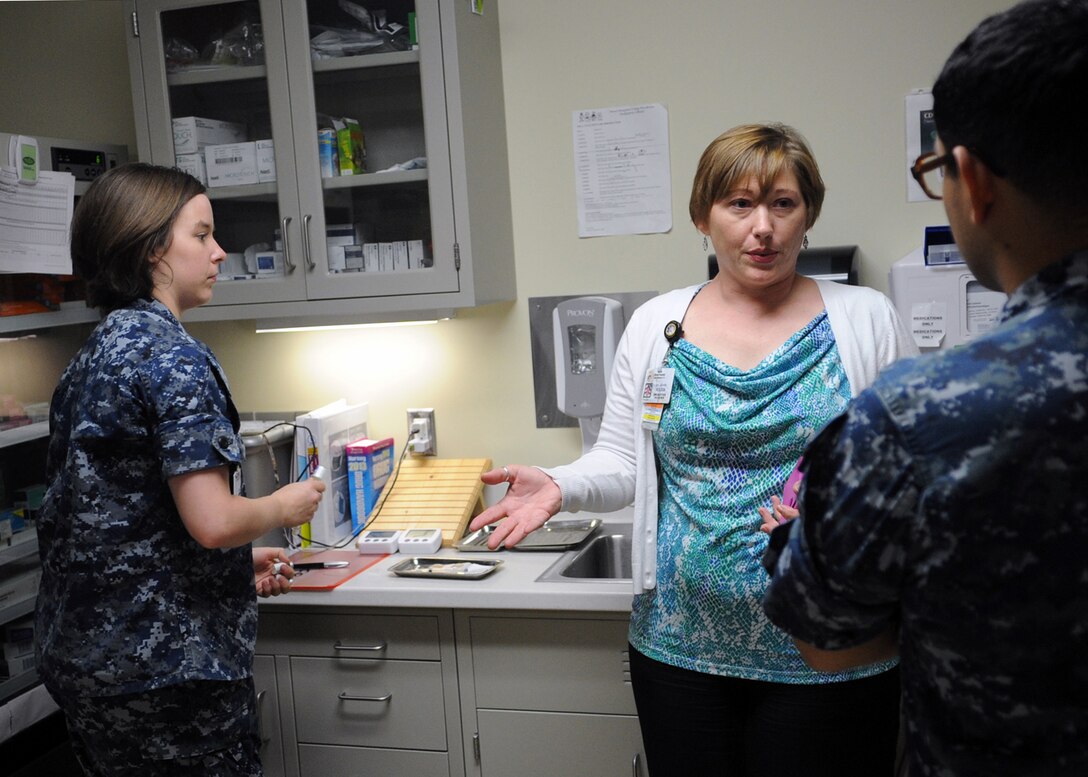 Jennifer Holden, Naval Hospital Camp Pendleton immunizations program nurse manager, discusses proper vaccine processes with sailors working in the NHCP Family Medicine Department’s immunization clinic during a recent survey.