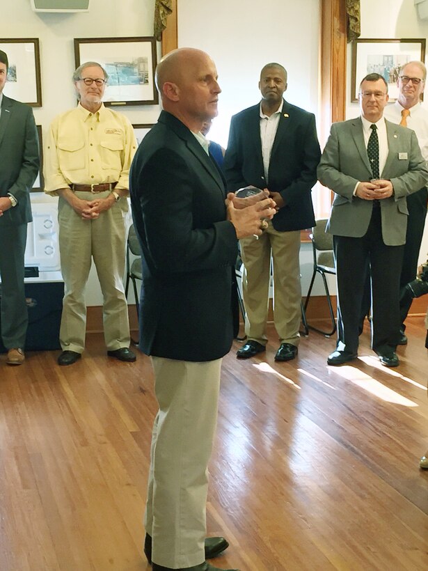 Dozens of community leaders came together at the Bridge House Conference Room located inside the Albany Convention and Visitors Bureau, Albany, Ga., to bid farewell to three top leaders at Marine Corps Logistics Base Albany, April 22. Dr. David Mosely, superintendent, Dougherty County School System, presented game balls to Col. Don Davis, commanding officer, MCLB Albany, and Maj. Gen. John Broadmeadow, commanding general, and Sgt. Maj. Joseph Davenport, sergeant major, both of Marine Corps Logistics Command, for their support of public education. Chris Cohilas, county commission chairman, Dougherty County Commission, and Tommy Clark, chairman, Albany Area Chamber of Commerce, presented awards to each for their community involvement and support.