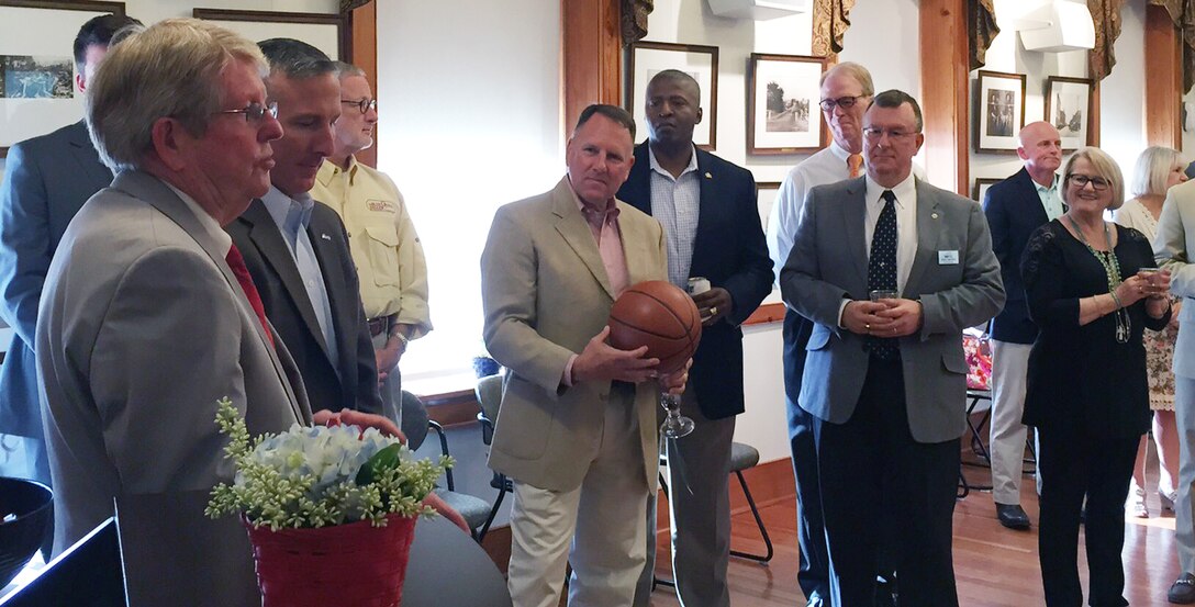 Dozens of community leaders came together at the Bridge House Conference Room located inside the Albany Convention and Visitors Bureau, Albany, Ga., to bid farewell to three top leaders at Marine Corps Logistics Base Albany, April 22. Dr. David Mosely, superintendent, Dougherty County School System, presented game balls to Col. Don Davis, commanding officer, MCLB Albany, and Maj. Gen. John Broadmeadow, commanding general, and Sgt. Maj. Joseph Davenport, sergeant major, both of Marine Corps Logistics Command, for their support of public education. Chris Cohilas, county commission chairman, Dougherty County Commission, and Tommy Clark, chairman, Albany Area Chamber of Commerce, presented awards to each for their community involvement and support.