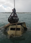 150423-N-IJ355-001 FORT PIERCE, Florida (April 13, 2015) - The wheel house of the sunken barge rises out of the Ft. Pierce Inlet waters barge where it had been blocking safe operations in the channel.  Salvage task managed by Naval Sea Systems Command's Supervisor of Salvage and Diving (SUPSALV) and conducted by SUPSALV's East Coast salvage contractor, DONJON Marine.