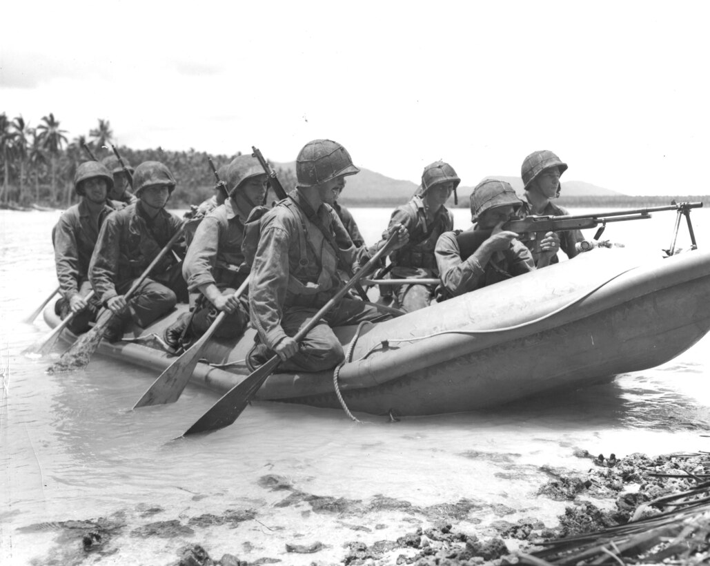 In this undated photograph, a Marine manning a Browning Automatic Rifle in the bow of a rubber raiding craft provides cover as a 10-man boat crew reaches the undefended beach of Pavuvu in the Russell Islands.
