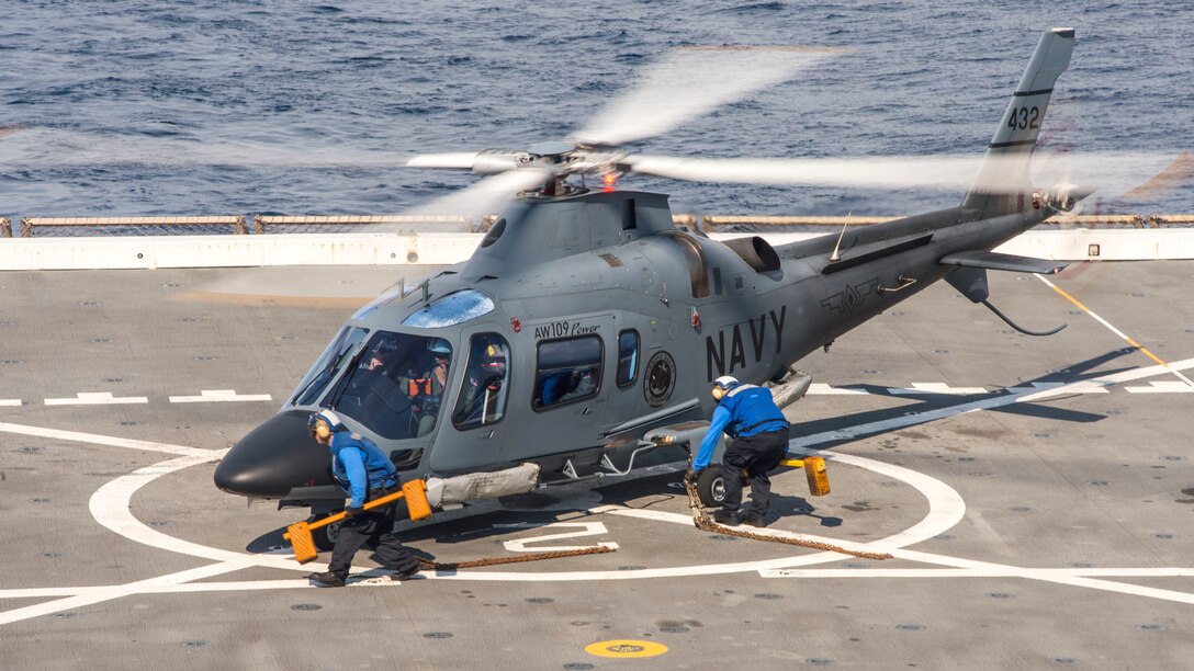 Sailors chock and chain a Philippine navy AW109 helicopter during flight operations aboard the amphibious transport dock ship USS Green Bay (LPD 20) during exercise Balikatan 2015. Green Bay is part of the Bonhomme Richard Amphibious Ready Group and, with the embarked 3rd Marine Expeditionary Force Forward, is currently participating in exercise Balikatan 2015, an annual, bilateral exercise conducted with the Armed Forces of the Philippines. (U.S. Navy photo by Mass Communication Specialist 3rd Class Edward Guttierrez III/Released)