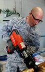 Tech. Sgt. Kristopher Dolehanty, 341st Civil Engineering Squadron NCO uses a ProPress machine to connect pipe fittings on a new water heater for the base swimming pool April 21, 2015, at Malmstrom Air Force Base, Mont. Dolehanty was recently selected to attend the Tri-Service Physician Assistant Training program. He has one year left in HVAC until he starts the PA program.(U.S. Air Force photo/Staff Sgt. Delia Marchick)