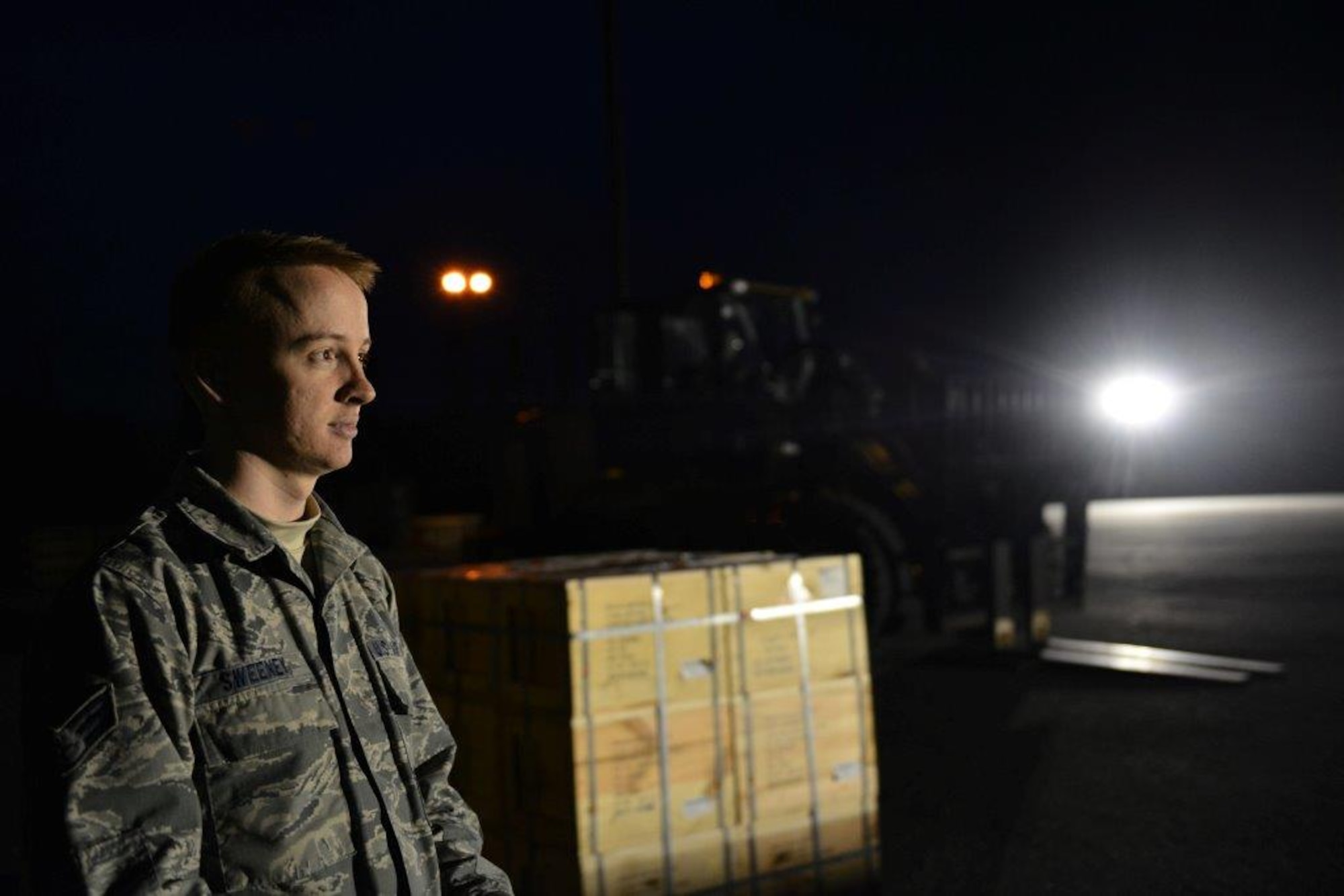 The first load of the ammunition containers arrive on Joint Base Elmendorf-Richardson April 15. Contracted forklift operators use their skills to unload each container weighing between 20,000 and 40,000 pounds. After they are offloaded from the trucks, the ammunition inspection team standing by opens the containers and inspects the ammunition before storing them into earth-covered igloos. (U.S. Air Force Photo/Airman 1st Class Kyle Johnson)