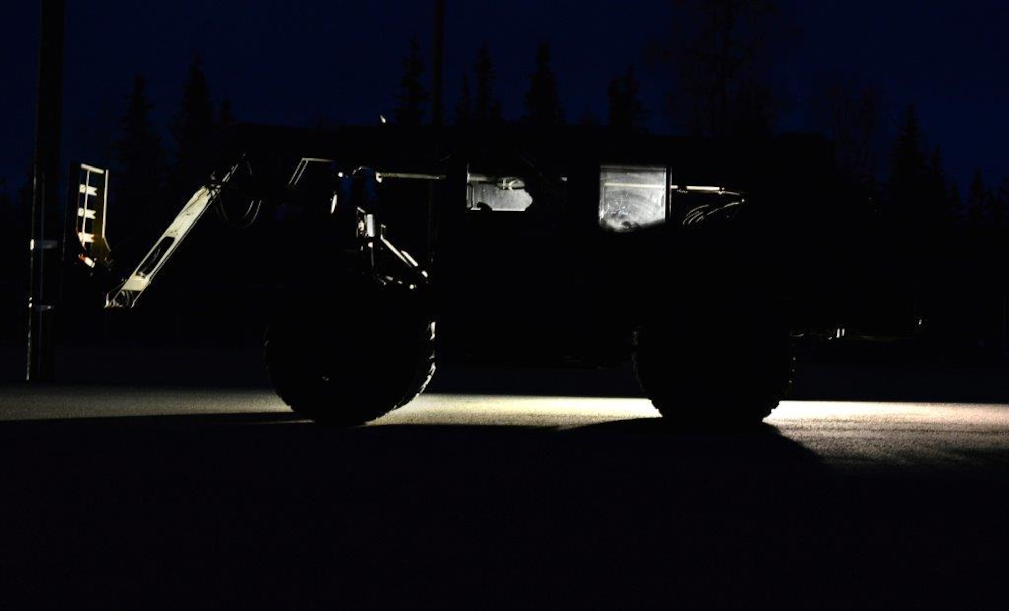 The first load of the ammunition containers arrive on Joint Base Elmendorf-Richardson April 15. Contracted forklift operators use their skills to unload each container weighing between 20,000 and 40,000 pounds. After they are offloaded from the trucks, the ammunition inspection team standing by opens the containers and inspects the ammunition before storing them into earth-covered igloos. (U.S. Air Force Photo/Airman 1st Class Kyle Johnson)