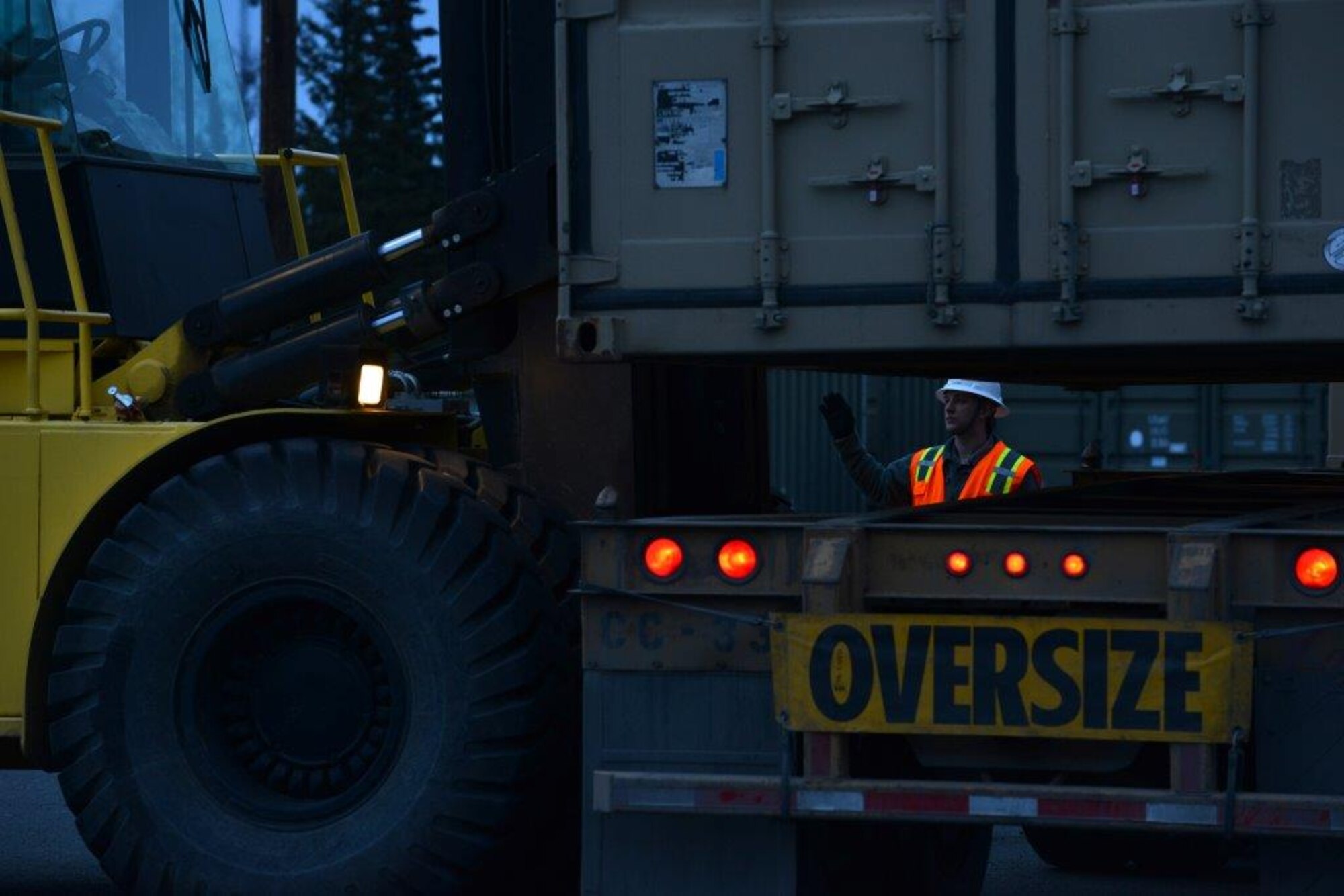 The first load of the ammunition containers arrive on Joint Base Elmendorf-Richardson April 15. Contracted forklift operators use their skills to unload each container weighing between 20,000 and 40,000 pounds. After they are offloaded from the trucks, the ammunition inspection team standing by opens the containers and inspects the ammunition before storing them into earth-covered igloos. (U.S. Air Force Photo/Airman 1st Class Kyle Johnson)