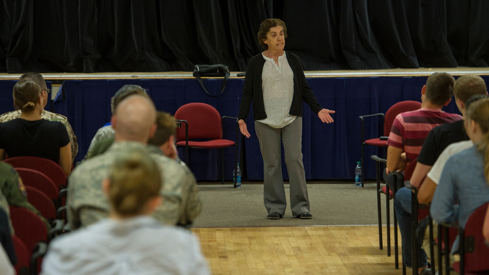 Theresa Dulgov, Holocaust survivor, tells the story of her experience living through the Holocaust during the Holocaust day of remembrance at Holloman Air Force Base, N.M., April 21, 2015. The German Air Force and Holloman invited Dr. Gail Wallen, founder and director of the military holocaust education program to speak to military members and a group of advanced placement history students from Alamogordo High School. Along with her were Theresa Dulgov and Lily Brull, both Holocaust survivors. (U.S. Air Force photo by Airman 1st Class Aaron Montoya / Released)