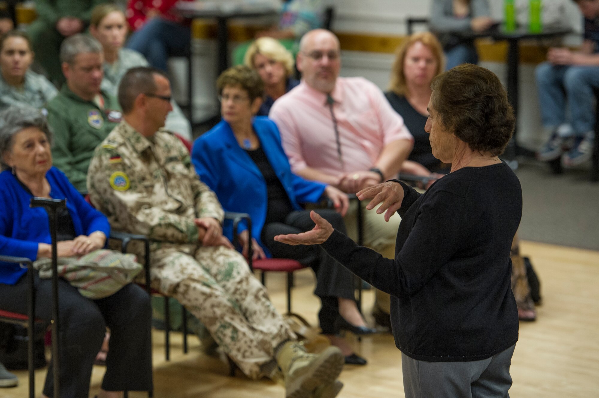 Theresa Dulgov, Holocaust survivor, informs a group of military members and students about her experience living through the Holocaust during the Holocaust day of remembrance at Holloman Air Force Base, N.M., April 21, 2015. Dulgov was invited by the German Air Force Flying Training Center and Holloman and was happy to have the opportunity to tell her story as she believes it will serve a large part in Holocaust education. “I think it’s marvelous because, I don’t think that younger people really understand what it was like living through the Holocaust. I need them to see and believe that this is what really happened, and to educate them about this tragedy,” said Dulgov. (U.S. Air Force photo by Airman 1st Class Aaron Montoya / Released)