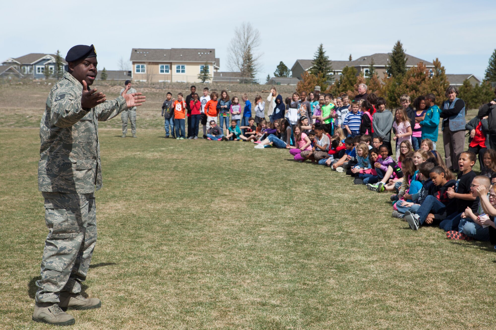 Tech. Sgt. Zerrick Shanks, 90th Security Forces Squadron military working dog trainer, addresses students at Freedom Elementary School, Cheyenne, Wyo., April 21, 2015. Ninetieth SFS's K-9 unit demonstrated tactics and techniques for the students to familiarize them with their mission. Ninetieth SFS is stationed with 90th Missile Wing on F.E. Warren Air Force Base, Wyo. (U.S. Air Force photo by Lan Kim)
