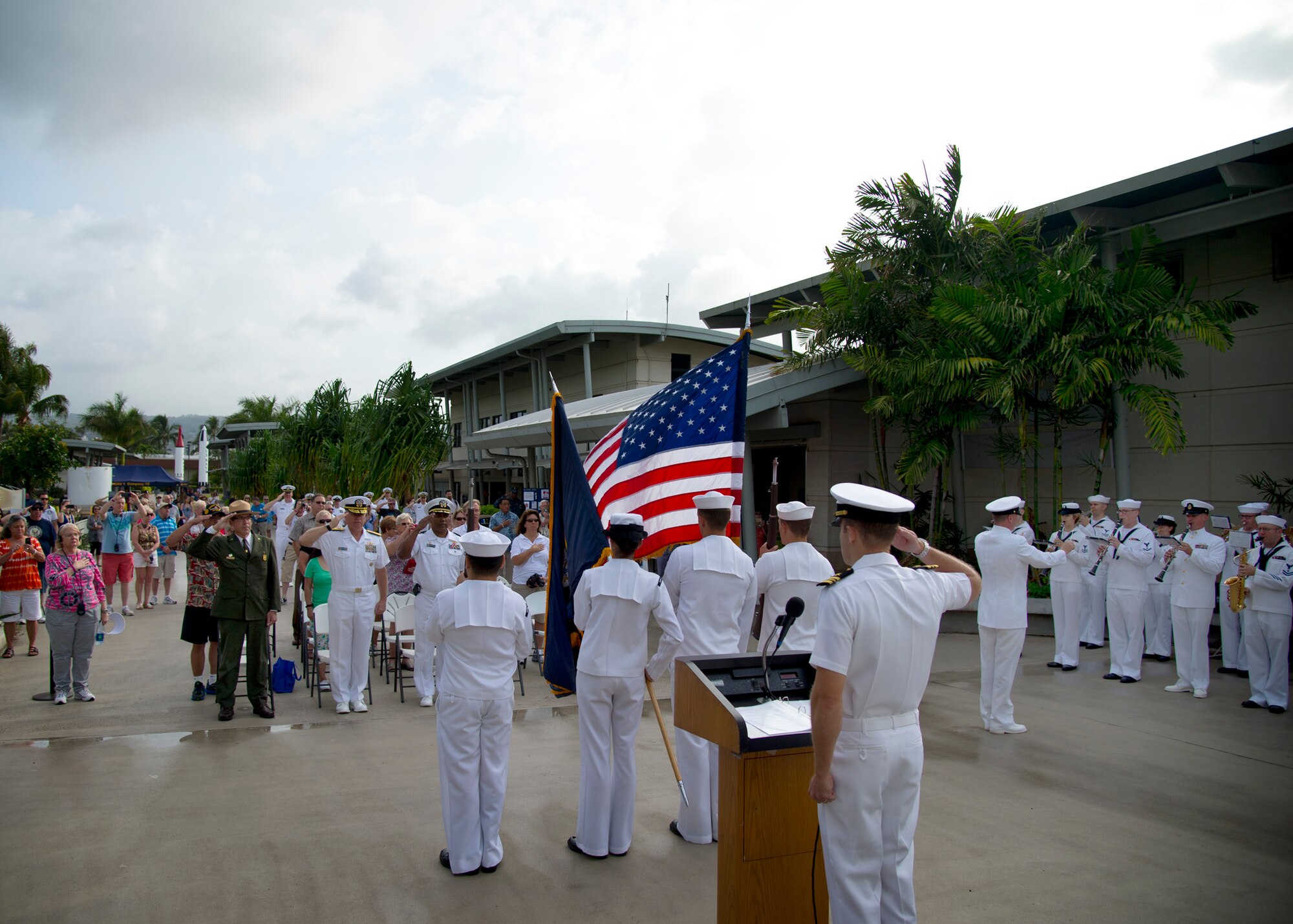 The Joint Base Honors and Ceremonies Guard present the colors while the U.S. Pacific Fleet Band performs the national anthem during the Pearl Harbor Colors ceremony at the Pearl Harbor Visitor Center, Hawaii, April 23 2015. Pearl Harbor Colors, a monthly military ceremony open to the public, is an opportunity for local residents and international visitors to witness a U.S. military ceremony and meet veterans, service members and their families. Attendees can learn about various aspects of military history. This month’s ceremony focused on the Navy’s efforts to contribute to a more sustainable environment. Additionally, the ceremony honored the National Park Service and celebrated National Park Week. (U.S. Air Force photo by Tech. Sgt. Aaron Oelrich/Released)