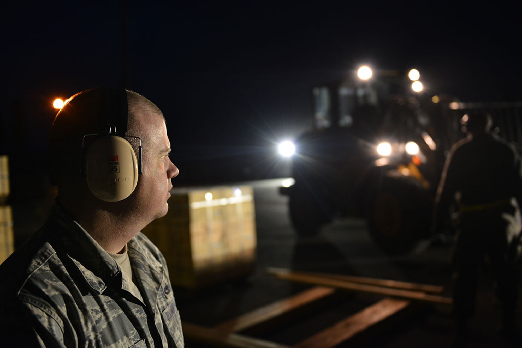 The first load of ammunition from the ‘ammo barge’ arrives on JBER April 15. Contracted forklift operators used their skills to unload containers, each weighing between 20,000 and 40,000 pounds. After they are offloaded from the trucks, the ammunition inspection team standing by opens the containers and inspects the ammunition before storing them in earth-covered bunkers. (U.S. Air Force photo/Airman 1st Class Kyle Johnson)