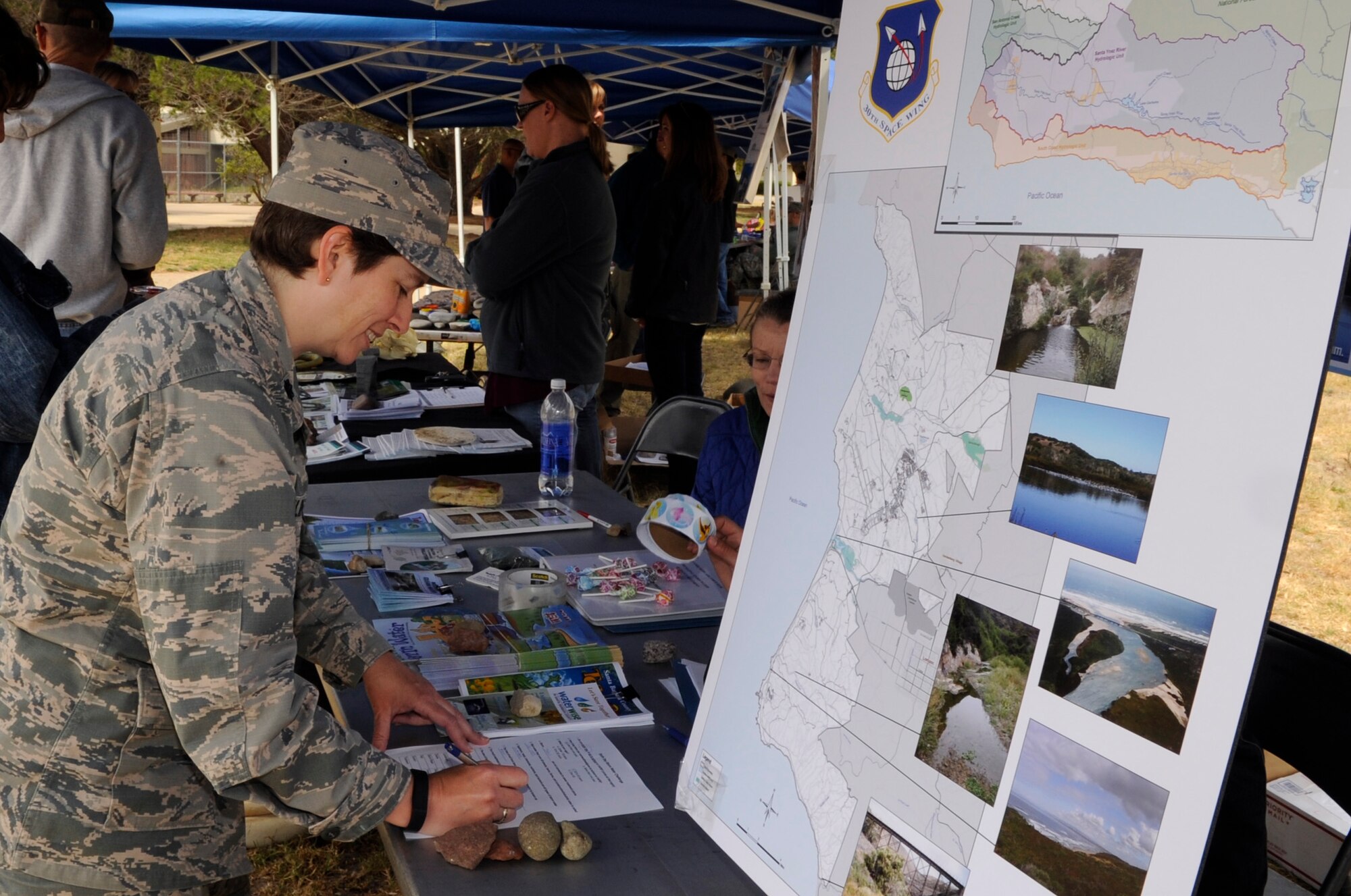 Lt. Col. Sacha Tomlinson, 17th Test Squadron detachment 4 commander, fills out a questionnaire at an Earth Day exhibit, April 22, 2015, Vandenberg Air Force Base, Calif. The Earth Day celebration included various exhibits for adults and children alike. (U.S. Air Force photo by Senior Airman Shane Phipps/Released)

