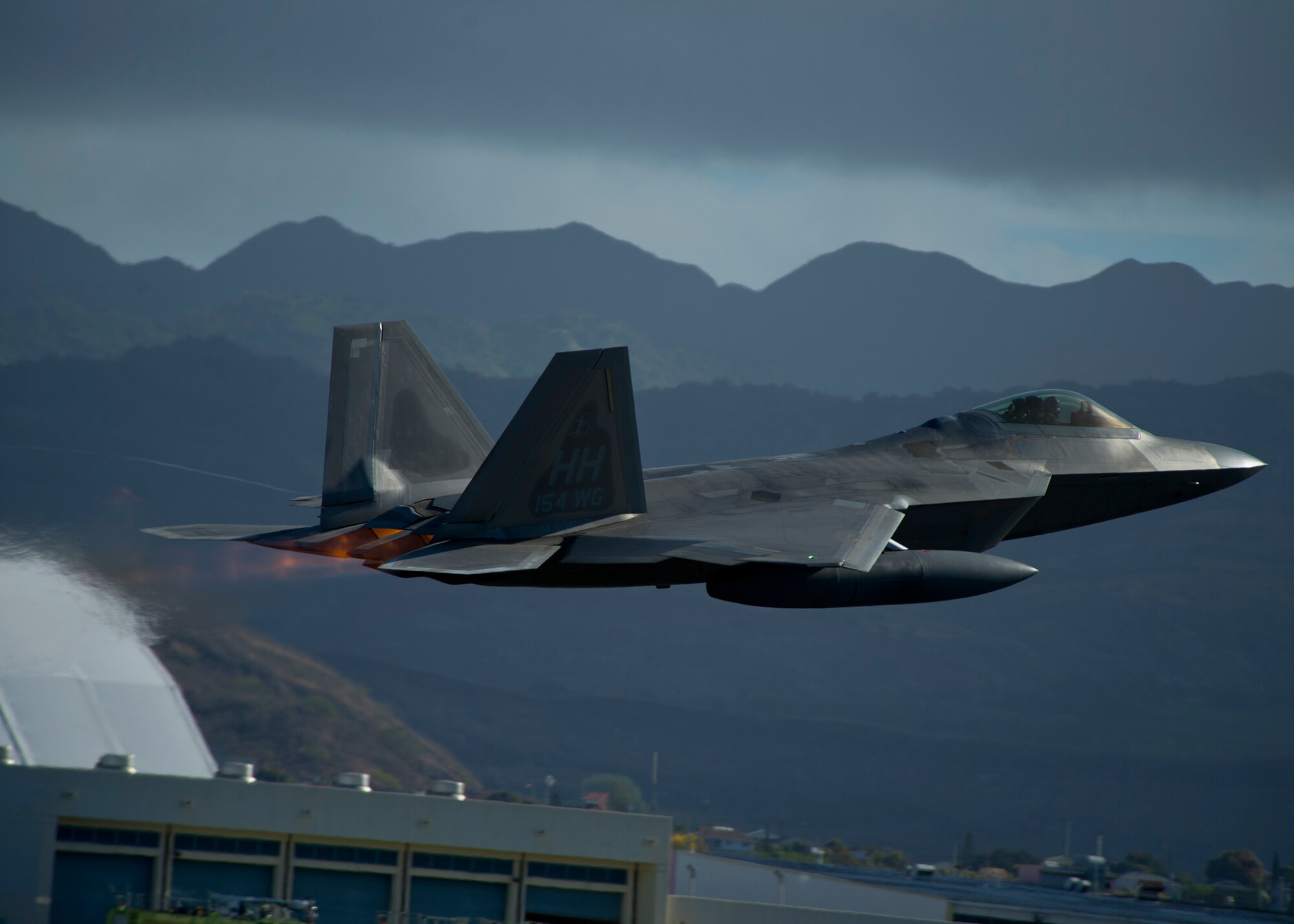 A United States Air Force F-22 Raptor, from the Hawaiian Raptors, takes off from Joint Base Pearl Harbor-Hickam, Hawaii, April 20, 2015. The F-22 Raptor has a range of 1,600 nautical miles with the two external wing fuel tanks attached. (U.S. Air Force photo by Tech. Sgt. Aaron Oelrich/Released)   