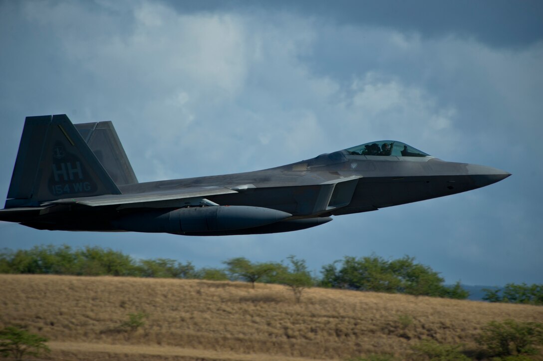 A pilot from the Hawaiian Raptors throws a Shaka sign, shortly after takeoff from Joint Base Pearl Harbor-Hickam, Hawaii, on his way to Nellis Air Force Base NV, to take part in a joint training April 20, 2015. (U.S. Air Force photo by Tech. Sgt. Aaron Oelrich/Released)   