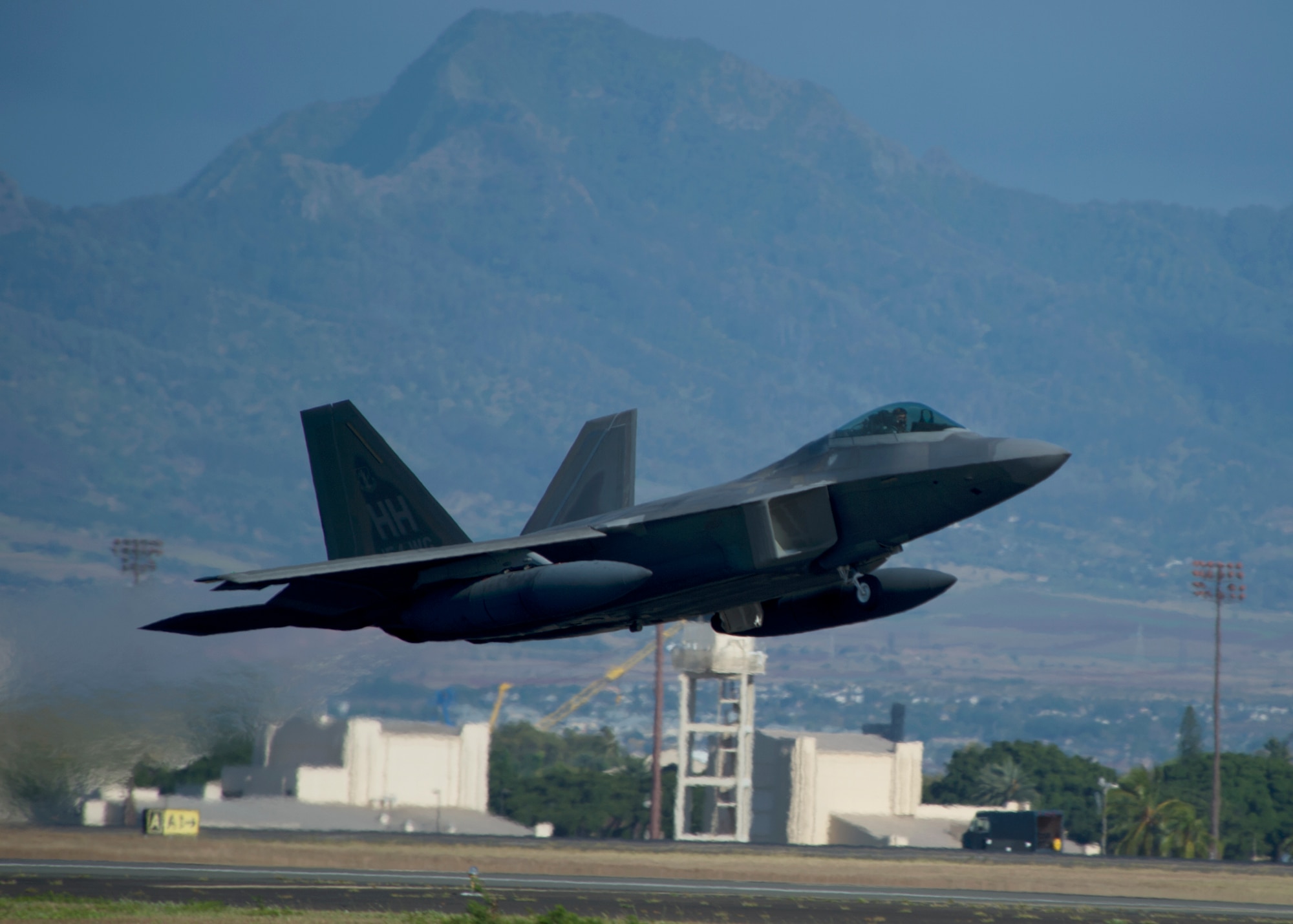 A United States Air Force F-22 Raptor, from the Hawaiian Raptors, takes off from Joint Base Pearl Harbor-Hickam, Hawaii, April 20, 2015. The Hawaiian Raptor is traveling to Nellis Air Force Base NV, to take part in a joint training event. (U.S. Air Force photo by Tech. Sgt. Aaron Oelrich/Released)   