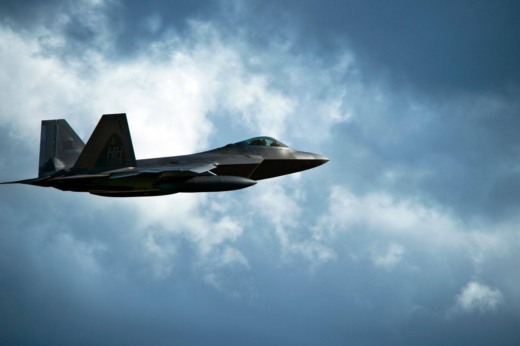 A United States Air Force F-22 Raptor, from the Hawaiian Raptors, increases altitude shortly after taking off from Joint Base Pearl Harbor-Hickam, Hawaii, April 20, 2015. The F-22's characteristics provide a synergistic effect ensuring F-22A lethality against all advanced air threats. The combination of stealth, integrated avionics and supercruise drastically shrinks surface-to-air missile engagement envelopes and minimizes enemy capabilities to track and engage the F-22 . (U.S. Air Force photo by Tech. Sgt. Aaron Oelrich/Released)     