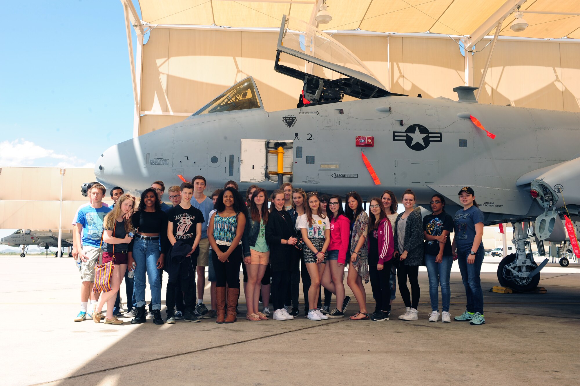 Buena Vista High school students and German cultural exchange students pose for a photo in front of an A-10C Thunderbolt II at Davis-Monthan Air Force Base Ariz., April 23, 2015. The students are part of the Sister City Program which allows students from foreign countries to visit the U.S. and experience our culture. During the visit to D-M the students toured the 563rd Operation Support Squadron, 357th Fighter Squadron and the Control Tower. (U.S. Air Force photo by Airman 1st Class Cheyenne Morigeau/Released)
