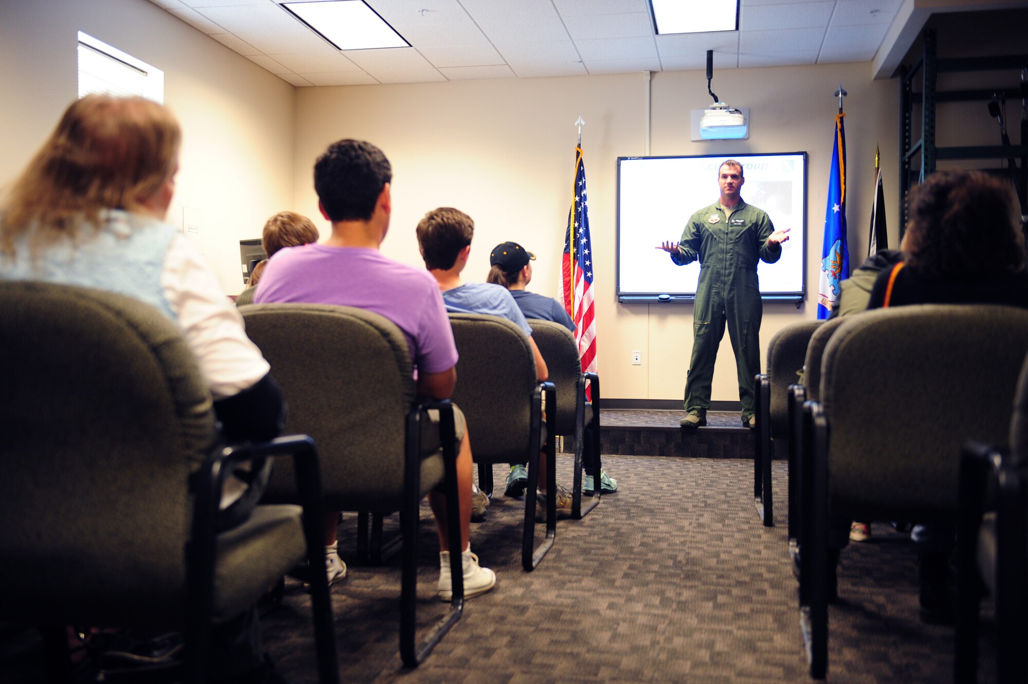 U.S. Air Force Capt. Jaymes Hines, 563rd rescue group executive, talks to a group of students at Davis-Monthan Air Force Base, Ariz., April 23, 2015. Hines spoke to students from Buena Vista High school as well as a group of German cultural exchange students about the mission of the 563rd RQG. (U.S. Air Force photo by Airman 1st Class Cheyenne Morigeau/Released) 