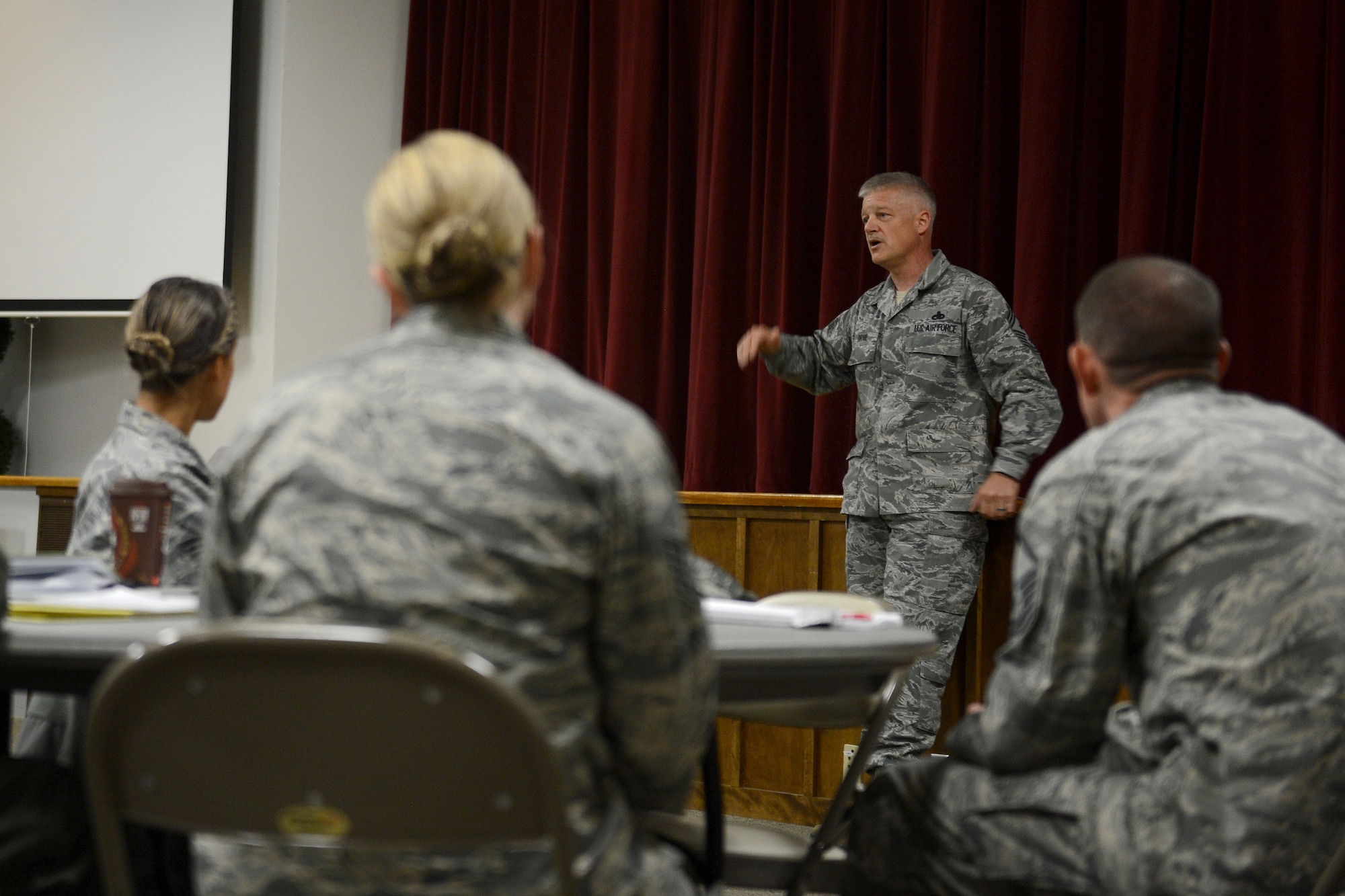 Chief Master Sgt. Gordon Drake, 62nd Airlift Wing command chief, gives a speech to participants of the First Sergeant Symposium, April 23, 2015, at Joint Base Lewis-McChord, Wash. Drake spoke about a few topics, such as the method in selecting first sergeants and then answered questions from the audience. (U.S. Air Force photo/Airman 1st Class Keoni Chavarria)