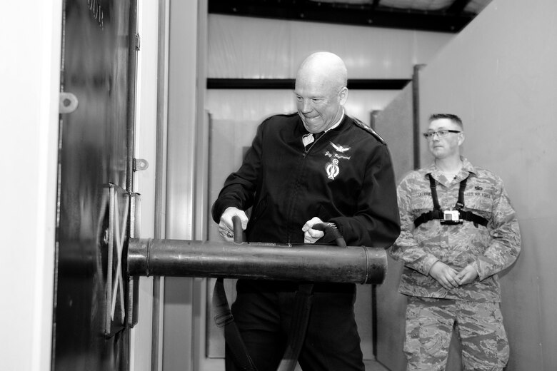 U.S. Air Force Lt. Gen. John W. "Jay" Raymond, commander, 14th Air Force (Air Forces Strategic) and Joint Functional Component Command for Space, breaches a door at the new 50th Security Forces Squadron shoot house April 17, 2015, at Schriever Air Force Base, Colo. Raymond spent the day visiting units at Schriever and engaging with Airmen regarding the mission. (U.S. Air Force Photo/Christopher DeWitt)