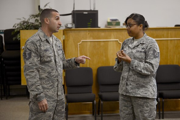 Master Sgt. Jason Torres (left), 627th Force Support Squadron first sergeant, talks with Tech. Sgt. Jacqueline Cunningham, 627th FSS mortuary affairs technician, about the First Sergeant Symposium, April 22, 2015, at Joint Base Lewis-McChord, Wash. During the symposium, participants learned many of the responsibilities first sergeants have and the resources available to them. (U.S. Air Force photo/Airman 1st Class Keoni Chavarria)