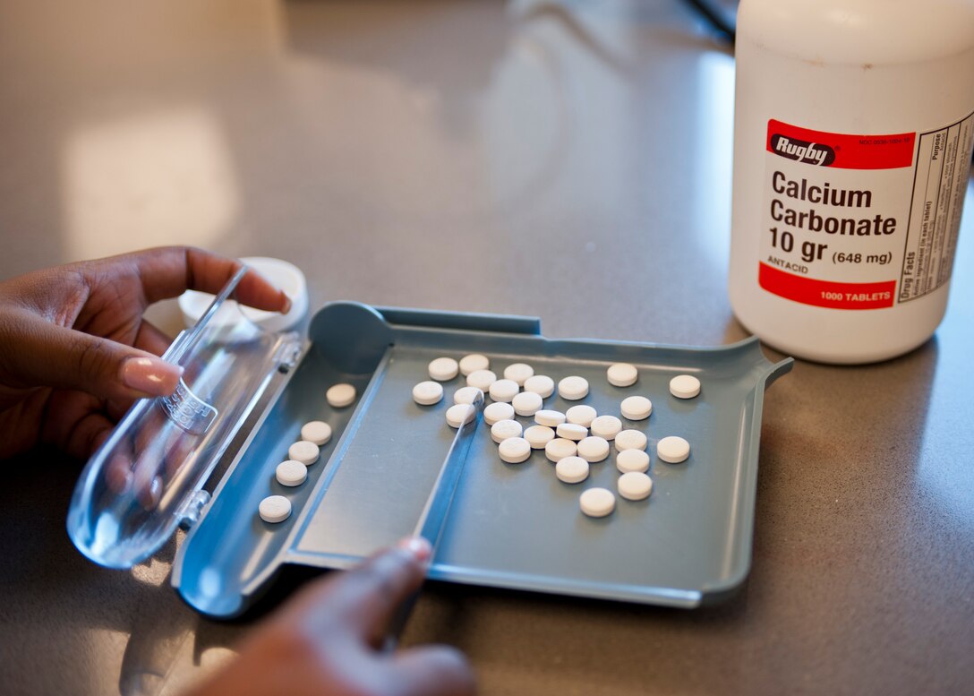 Airman 1st Class Celexus Thomas, 99th Medical Support Squadron pharmacy technician, counts pills for a prescription at the satellite pharmacy on Nellis Air Force Base, Nev., April 17, 2015. This is part of the extra process controlled medications are subject to due to legal requirements (U.S. Air Force photo by Airman 1st Class Jake Carter)