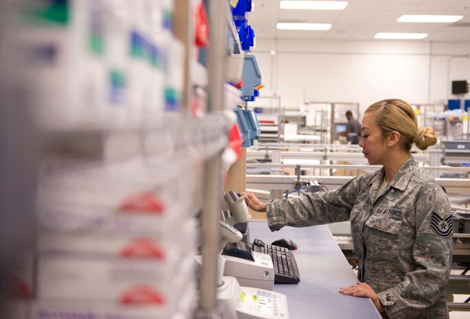 Tech. Sgt. Flordeliza Sia, 99th Medical Support Squadron pharmacy technician, refills a presciption at the satellite pharmacy on Nellis Air Force Base, Nev., April 17, 2015. The satellite pharmacy, which is staffed by 18 pharmacists, 50 technicians and approximately 30 volunteers, fills approximately 3,500 prescriptions a day. (U.S. Air Force photo by Airman 1st Class Rachel Loftis)