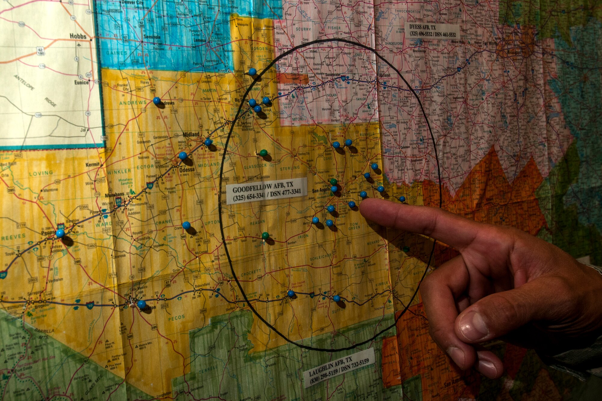 GOODFELLOW AIR FORCE BASE, Texas – Staff Sgt. Albert L. Hetrick, 17th Training Wing Honor Guard NCO in charge, illustrates his unit’s area of responsibility on a map at Heath Hall April 23. The yellow coloring, not the circle, depicts the region that the Honor Guard performs details. (U.S. Air Force photo/ Senior Airman Scott Jackson)