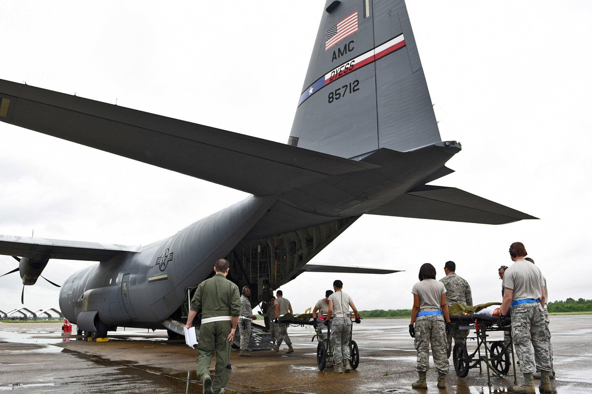Airmen from the 59th Medical Wing, Joint Base San Antonio-Lackland, Texas, load simulated patients onto a U.S. Air Force C-130 cargo aircraft during an Ultimate Caduceus 2015 exercise at Naval Air Station Joint Reserve Base New Orleans, La., April 16, 2015. Ultimate Caduceus 2015 will consist of two disaster aeromedical staging facilities deployed at NAS JRB New Orleans, staff 12-hour operations and process 280 patients each day. (U.S. Air National Guard Photo by Master Sgt. Dan Farrell, 159th Fighter Wing Public Affairs Office/Released)