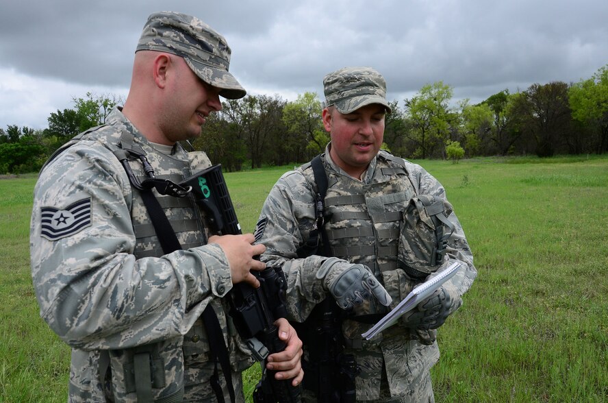 FORT WOLTERS TRAINING CENTER, Texas -- Tech. Sgt. Thomas Sexton (right) reviews Counter Improvised Explosive Device procedures with his brother, Tech. Sgt. Timothy Sexton, during the Patriot Defender training course at Fort Wolters Training Center, Texas. The 445th Security Forces members attended the training Apr 6-17 to hone their expeditionary security forces skills. (U.S. Air Force Photo by SrA Joel McCullough)