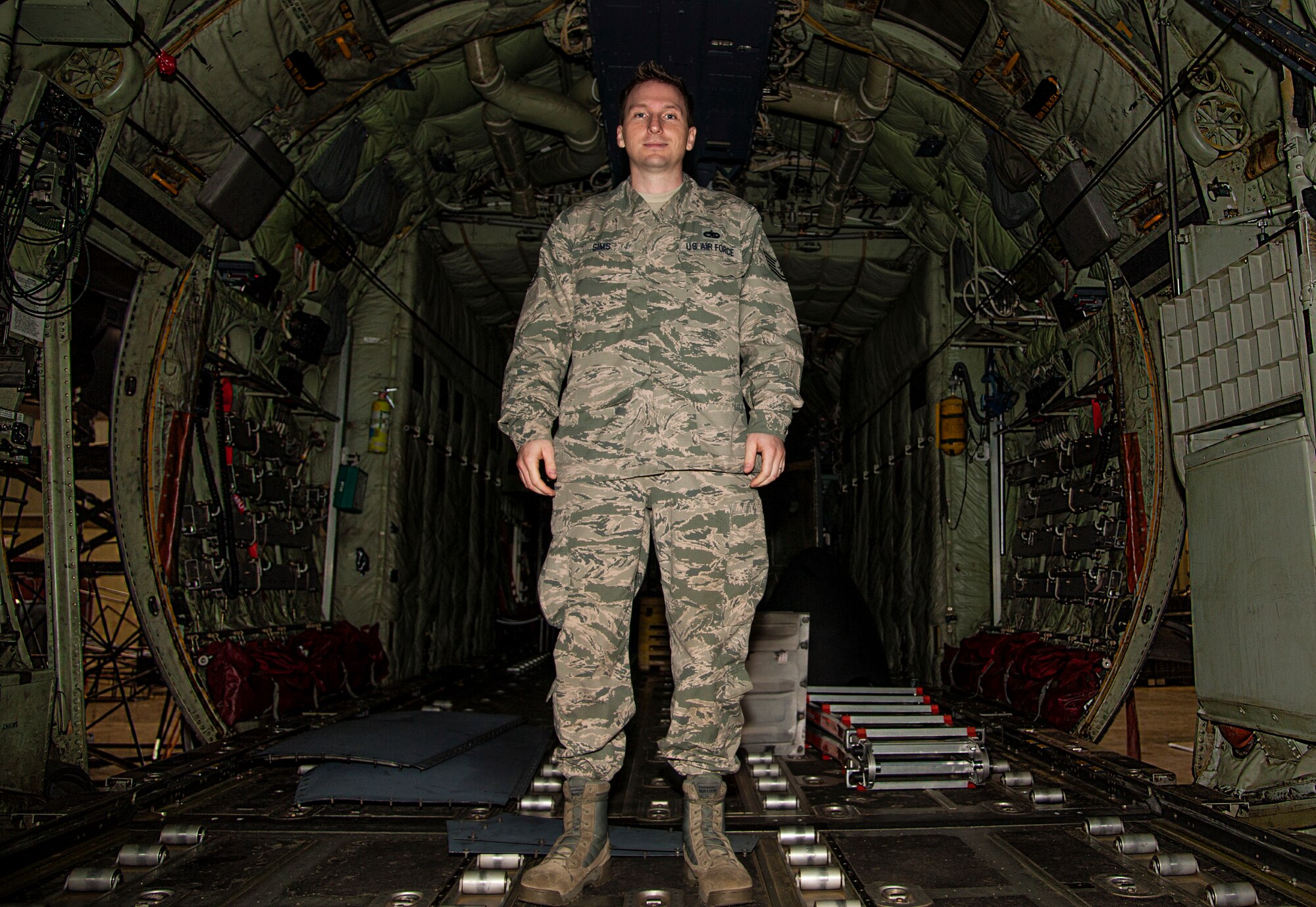 Tech. Sgt. Eric Sims, a 314th Aircraft Maintenance Squadron hydraulic systems craftsman, stands in the back of a C-130H April 17, 2015, at Little Rock Air Force Base, Ark. Sims was awarded the 2014 Air Force Lt. Gen. Leo Marquez Maintenance Award. (U.S. Air Force photo by Senior Airman Harry Brexel) 

