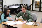 Elisabeth Gonzales (left), daughter of Chief Master Sgt. Terry Best-Rennahan, receives chemistry tutoring from Capt. Christopher Umphres, 435th Fighter Training Squadron instructor pilot, April 14 at the Joint Base San Antonio-Randolph library. Tutoring is offered 6-7 p.m. each Tuesday and Thursday at the library. For more information, call 652-5578 or 652-2617. (U.S. Air Force photo by Airman 1st Class Alexandria Slade)
